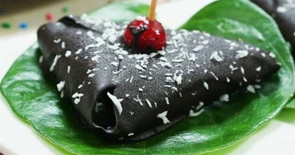 A paan decadently covered in chocolate sauce.